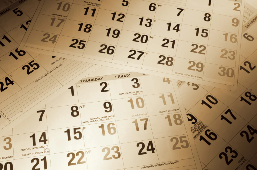 Printed calendar pages illustrating the history of calendars and how they organize time.