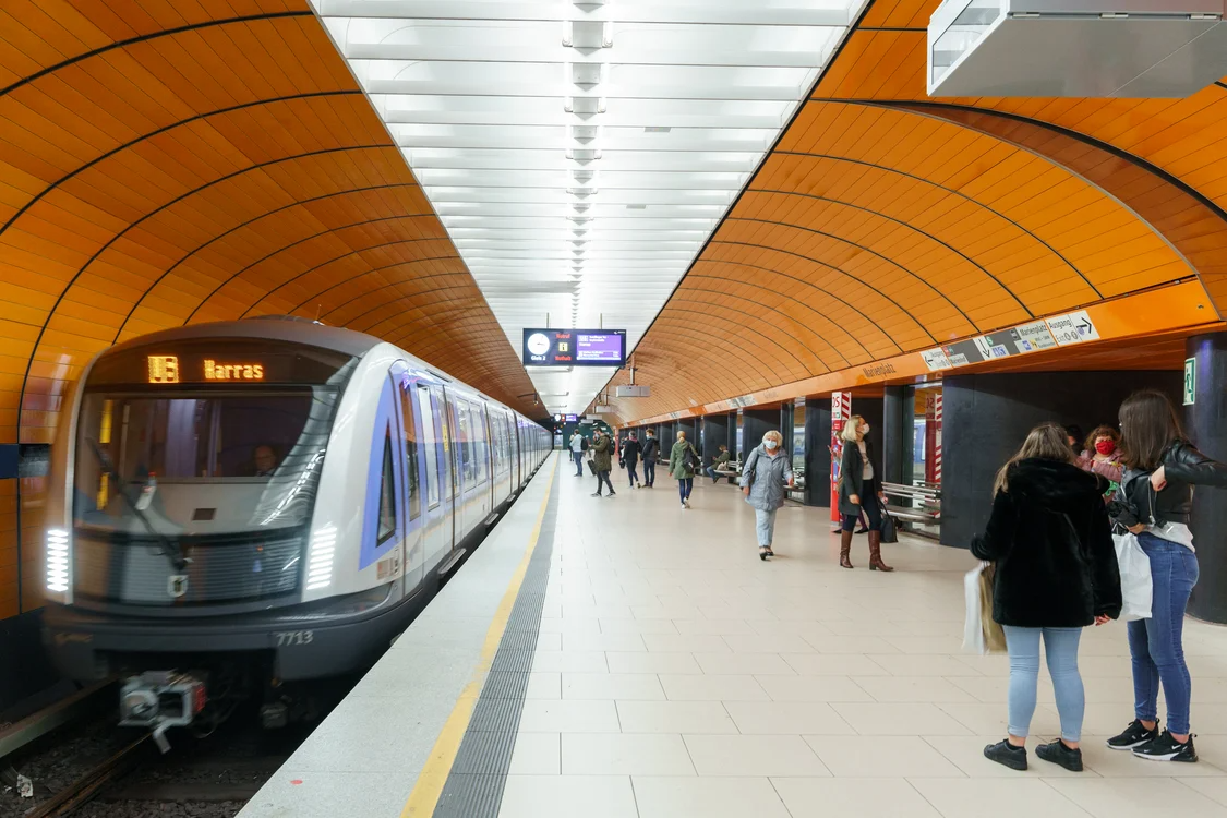 Modern subway station with commuters, illustrating why public transit is better in some cities.