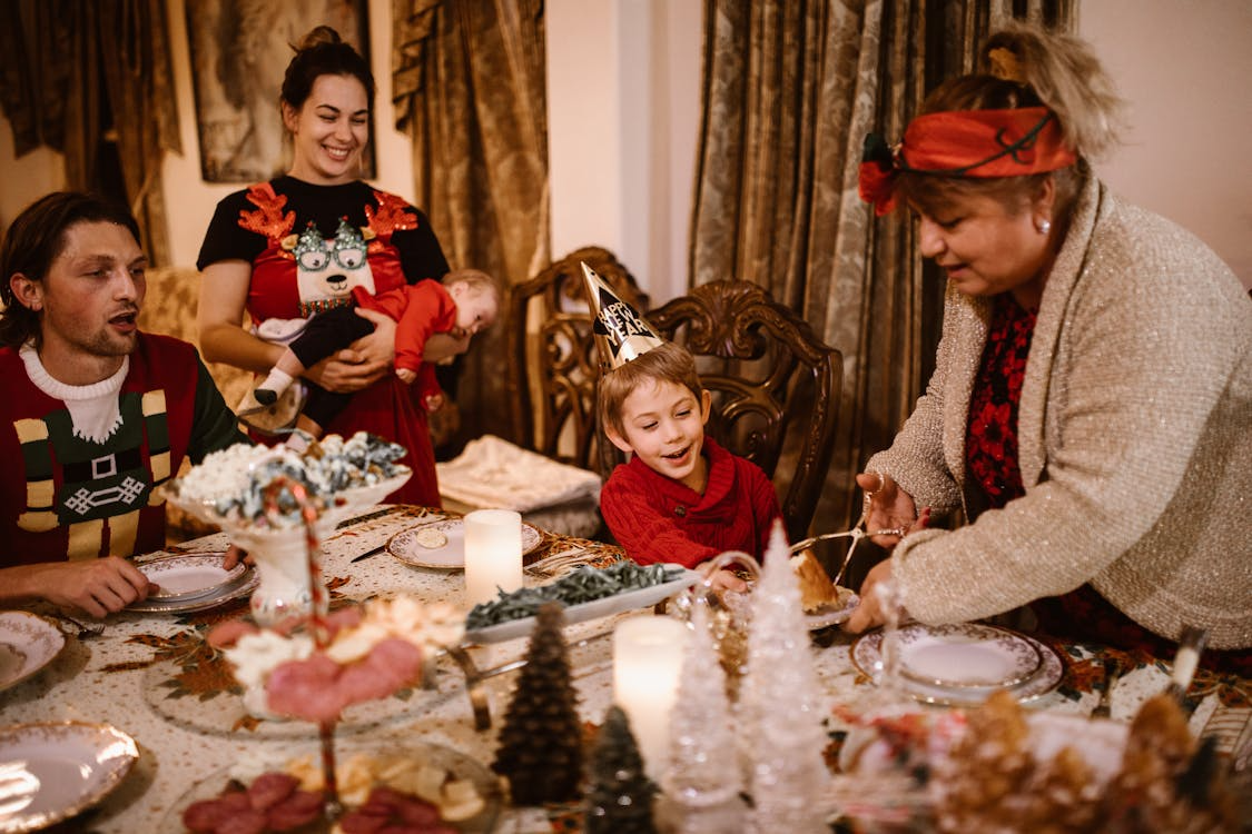 Family gathered around a holiday table, illustrating why traditions persist through shared rituals.