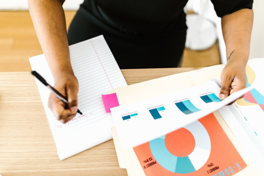 Person reviewing charts and notes, illustrating correlation vs causation in data interpretation.