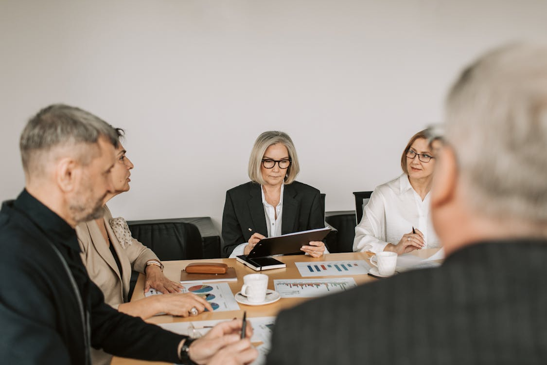 Experts reviewing reports in a meeting, illustrating why experts disagree when interpreting data.